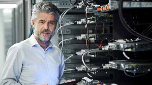 man working with tablet server room